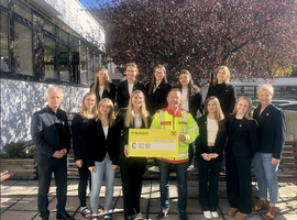 Gruppenfoto mit Personen, die einen Scheck über 382,80 Euro präsentieren.